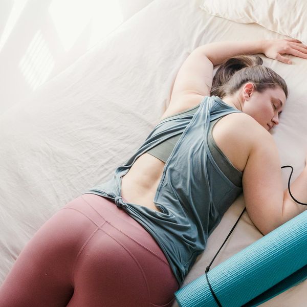 Woman in a calm, restorative pose indoors.